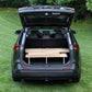 The trunk of a CarToCamp Toyota RAV4 Sleeping Platform with storage space.
