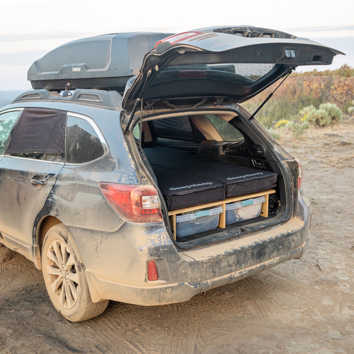 The trunk of a Subaru Outback with a Deepsleep Solo Mat for Toyota RAV4 by CarToCamp in it.